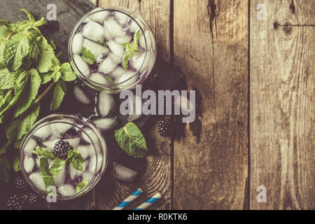 Blackberry mojito and ingredients on rustic background Stock Photo