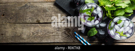 Blackberry mojito and ingredients on rustic background Stock Photo