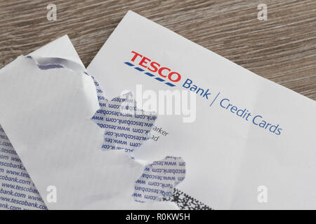 Tesco Bank Credit Card statement on table with ripped open envelope. Stock Photo