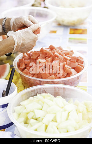 Chunks of watermelon and melon, detail of a person cutting in summer fruit, healthy food, soda Stock Photo