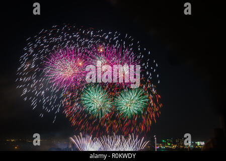 Explosion of colorful firecrackers in night sky Stock Photo