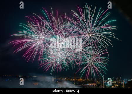 Explosion of colorful firecrackers in night sky Stock Photo