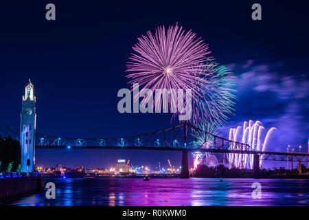 Fireworks display over a city bridge Stock Photo