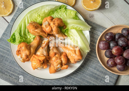 Roast chicken wring on the wooden table Stock Photo