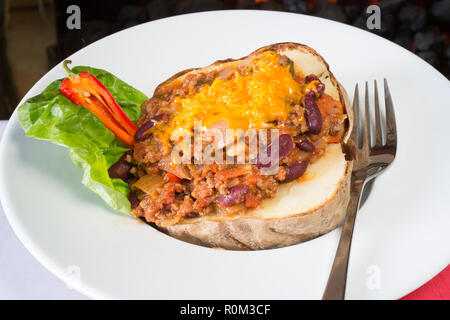 Oven baked jacket potato with a minced Beef Chili filling topped with grated Cheese. Stock Photo