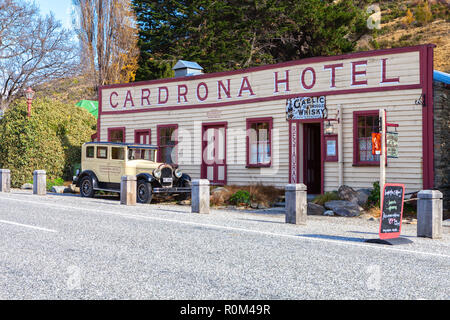 Cardrona Valley Road,  Cardrona, South Island, New Zealand - May 10, 2013:  Famous historic Cardrona Hotel and vintage car. Stock Photo