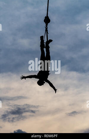 BERLIN, GERMANY - July 29, 2018: Sihluette of a male Bungee Jumper against dramatic skies Stock Photo