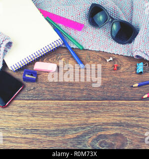 Set of items office mobile notebook sketch pencils markers eraser glasses. Wooden dark background top view flat lay copy space Stock Photo