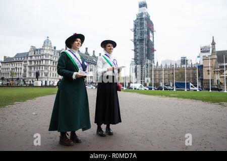 London, UK. 6th November, 2018. Activists from Feminist Fightback dressed as suffragettes hand out leaflets in Parliament Square after the sign on the new Millicent Fawcett statue was changed from ‘Courage calls to Courage Everywhere’ to ‘Feminists demand healthcare for all’ in protest against NHS charges for migrants. Under the new NHS charging system, migrants not considered ‘settled’ in the UK are being charged up to £7000 for pregnancy care and £1300 for an abortion in an NHS hospital. Credit: Mark Kerrison/Alamy Live News Stock Photo