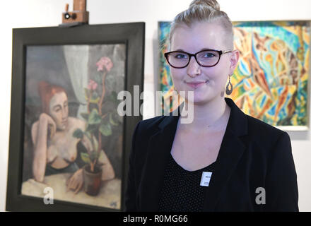 Schleswig, Germany. 06th Nov, 2018. Melanie Jacobi, provenance researcher at the Museum of Art and Cultural History, stands next to the painting 'Girl with Geranium' by Karl Hofer (1878-1955). For more than five years, the Schleswig-Holstein State Museums Foundation has been systematically examining and processing the collections of the Museum of Art and Cultural History. It is supported by the German Centre for the Loss of Cultural Assets in Magdeburg. Credit: Carsten Rehder/dpa/Alamy Live News Stock Photo
