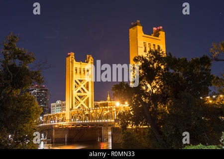 Night view of the Tower Bridge connecting Sacramento to West Sacramento; downtown area skyline visible in the background; California Stock Photo
