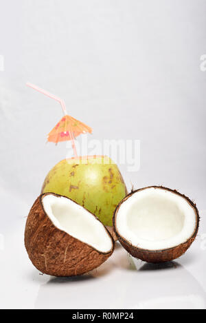 Broken coconut and green coconut isolated on white background Stock Photo