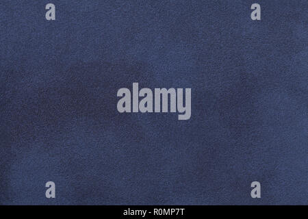 Navy blue matte background of suede fabric, closeup. Velvet texture of seamless denim leather. Stock Photo