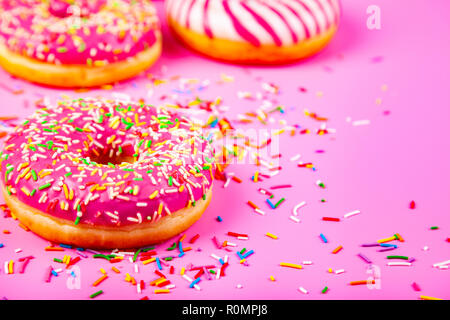 Donuts on a pink background. Delicious dessert. Stock Photo