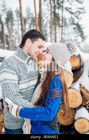 Young guy and girl in winterwear enjoying snowfall Stock Photo