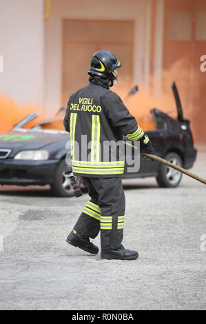 Italia, Italy - May 10, 2018: brave italian fireman during the practice drill at fire station with the fire truck. The text Vigili del Fuoco means Fir Stock Photo
