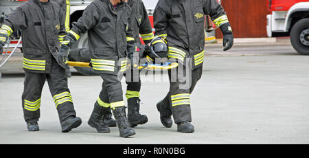 Italia, Italy - May 10, 2018: Italian porter firefighters transport an injured on the stretcher during a practical rescue exercise Stock Photo
