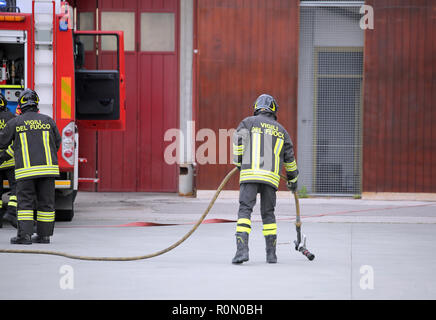 Italia, Italy - May 10, 2018: Italian firemen with fire truck during a practical roadside rescue exercise Stock Photo