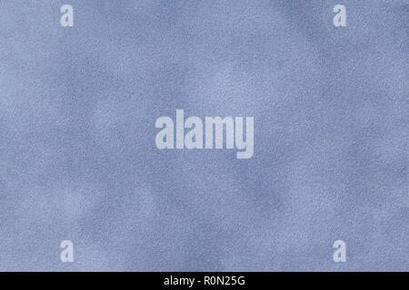 Light blue matte background of suede fabric, closeup. Velvet texture of seamless leather. Stock Photo