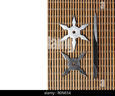Closeup Ninja Star Shurikens with throwing spikes on Wooden Background, Copy Space Stock Photo