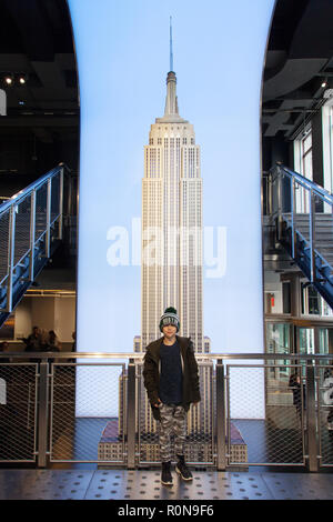 9 year old boy in front of a model of the Empire State Building, Manhattan, New York City, United States of America. Stock Photo