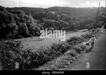 black and white photograph taken on film of a Stroud scene with child Stock Photo