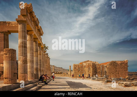 LINDOS, GREECE - OCTOBER 04, 2018: The ruins of this ancient citadel at Lindos sits proudly atop a steep cliff with sea views and can be reached by fo Stock Photo