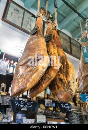 Jamon Serrano (cured hams) hangin up in a tapas bar in the Barrio Santa Cruz, Seville, Andalucia, Spain Stock Photo