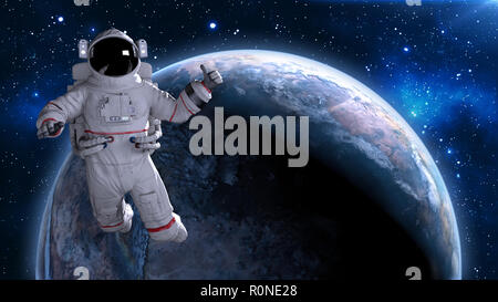 Astronaut in space giving thumbs up, cosmonaut floating above planet Earth, 3D rendering Stock Photo