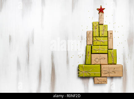 Christmas gift boxes laid out in the shape of a Christmas tree with decoration for mock up template design. overhead view, copy space Stock Photo