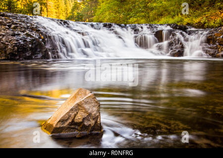 A small cascade along the Eagle Creek Trail in Oregon, USA, with focus on the rock in the foreground Stock Photo