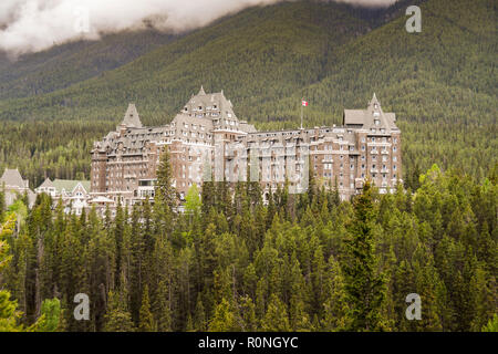 BANFF, AB, CANADA - JUNE 2018: The Banff Springs Fairmont Hotel among evergreen trees in Banff Stock Photo