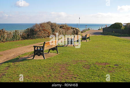 A row of seats on the top of cliffs overlooking the sea with beach access in North Norfolk at Overstrand, Norfolk, England, United Kingdom, Europe. Stock Photo