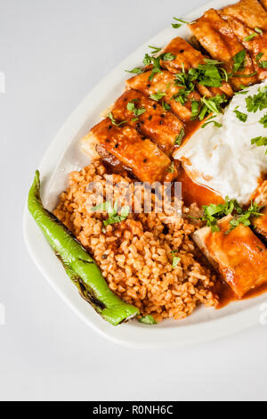 Turkish Beyti Kebab served with bulgur pilaf and yoghurt Stock Photo