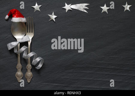 Christmas abstract table with silver cutlery and stars in night on marble black background Stock Photo