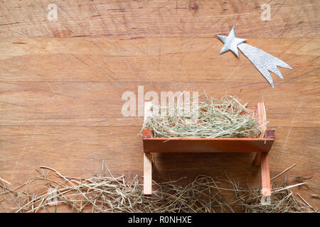 Wooden manger and star of Bethlehem in cave, nativity scene background ...