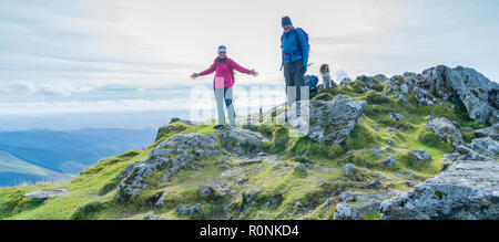 Two people standing on the summit of Cadair Idris in Snowdonia National Park, Wales, UK Stock Photo