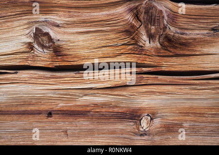 old weathered wood beam with cracks and branches from front of alpine hut Stock Photo