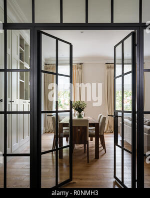 Open glass doors to dining room Stock Photo