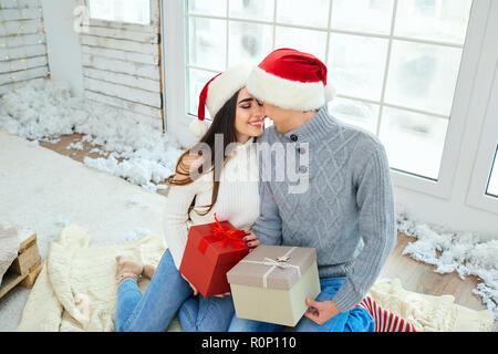 Happy young couple  having fun at Christmas. Stock Photo
