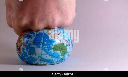 World globe is crushed by a man's fist, ecological problems Stock Photo ...