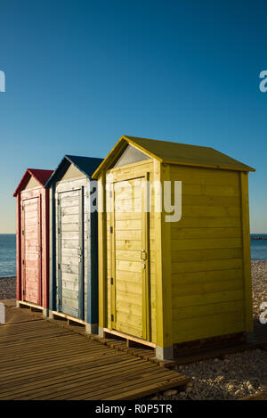 Several multicolored huts on a Mediterranean resort beach Stock Photo