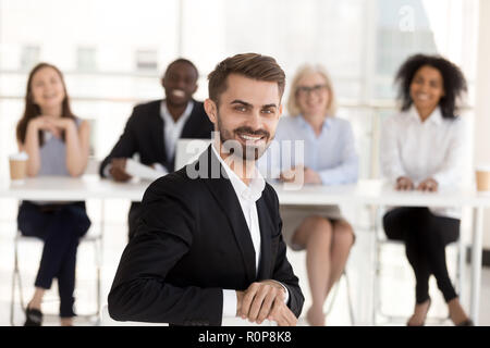 Portrait of smiling male candidate posing during work interview Stock Photo