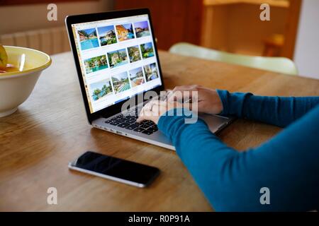 Woman's hands working from home typing on laptop Stock Photo