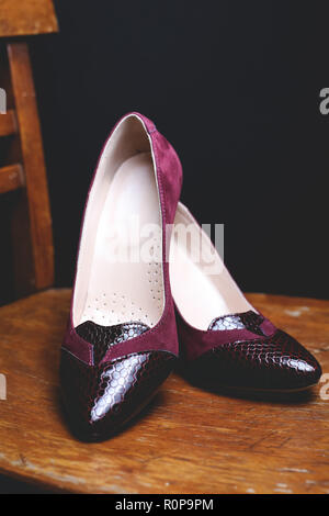 female shoes on wooden chair Stock Photo
