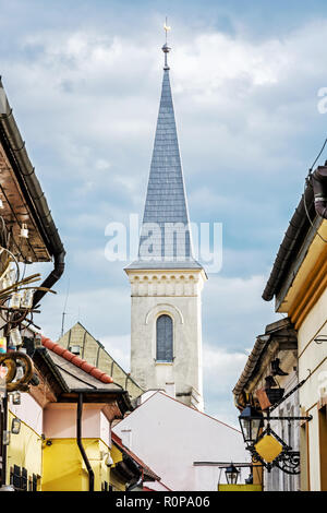 Hrnciarska street with Calvinist church in Kosice, Slovak republic. Folk art theme. Religious architecture. Stock Photo