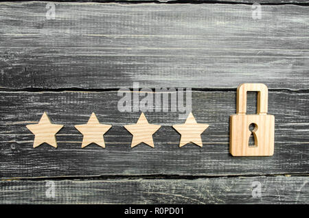 Four stars and a padlock. The concept of assigning the fifth star, a limitation in the ranking. The desire to get the fifth star. Improving the qualit Stock Photo