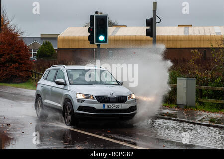 Clonakilty, West Cork, Ireland. 6th Nov, 2018. A car drives through a pool of water after a morning of torrential rain in Clonakilty. Rain is forecast for the rest of the week with Friday being very wet and windy. Credit: Andy Gibson/Alamy Live News. Stock Photo