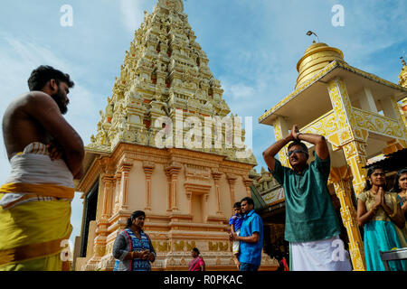 Hindu perform a special prayer inside the temple during Diwali festivals on November 6, 2018 in Kuala Lumpur, Malaysia. Almost 6.4 percent Hindu populations in Malaysia celebrated Diwali, the festivals of light called 'Deepavali' on November 6. The Hindu community, which consists of eight percent of Malaysia's population of 32 million, will celebrate Diwali, people light small oil lamps called diyas. It is believed that deceased relatives come back to visit their families on Earth during this festival and the lights are a way to guide the spirits home, the celebration revolves around the trium Stock Photo