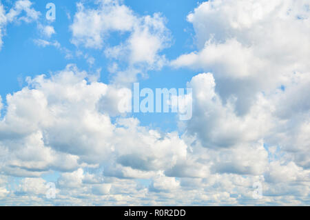 Wavy, porous curly clouds on the blue sky. Nature background. Stock Photo